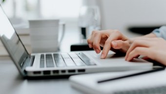 a typing hand in laptop