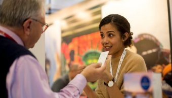 a young lady talking to a man in the wtm london event