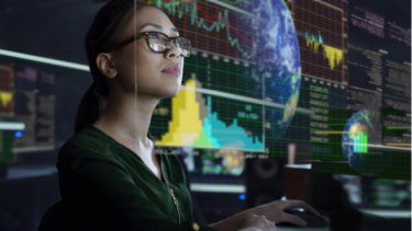 A woman with eyeglasses looking in different graphs and typing