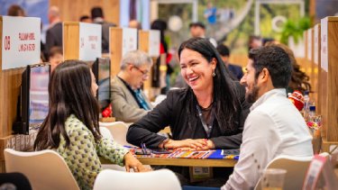 three women happy chatting while sitting in one table