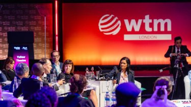 three women happy chatting while sitting in one table
