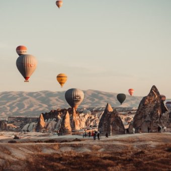 hot air balloons above the mountains
