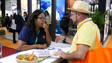 Man and a woman talking at WTM Latin America