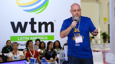 Man talking with more people in the background at WTM Latin America