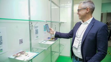 A man looking on the WTM London brochures