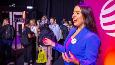 girl with a blue blazer explaining something